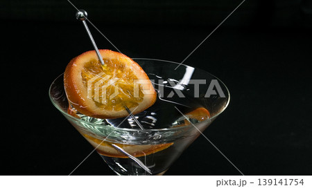 Martini glass with orange slice garnish for celebration Martini glass with orange slice garnish for celebration 139141754