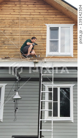 Construction Worker Painting Wooden House Exterior Construction Worker Painting Wooden House Exterior 139142304