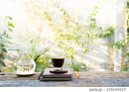 Coffee glass cup and stack of notebook Coffee glass cup and stack of notebook 139144537