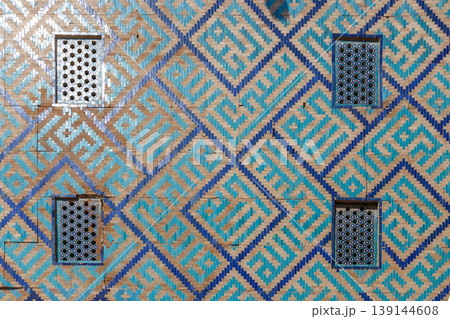 Geometric kufic script tilework and lattice windows on Sher Dor Madrasah facade in Samarkand Geometric kufic script tilework and lattice windows on Sher Dor Madrasah facade in Samarkand 139144608