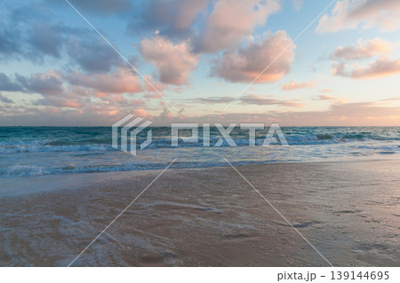 Calm beach at sunset with gentle turquoise waves Calm beach at sunset with gentle turquoise waves 139144695