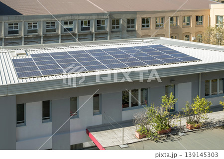 Solar Panels Installed on Building Roof for Renewable Energy Production 139145303