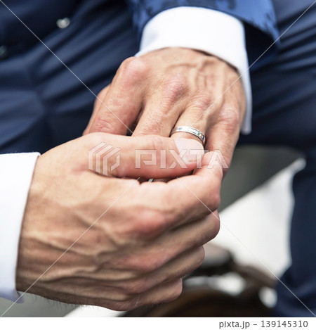 Man Adjusting Wedding Ring Man Adjusting Wedding Ring 139145310