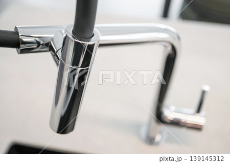Modern Chrome Faucet Detail in Minimal Kitchen Interior Modern Chrome Faucet Detail in Minimal Kitchen Interior 139145312