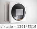 Modern Smart Thermostat on Wall for Home Climate Control 139145316