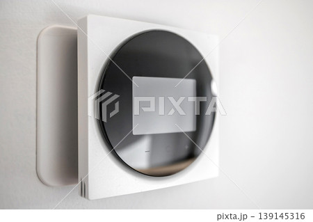 Modern Smart Thermostat on Wall for Home Climate Control 139145316