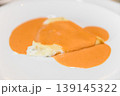 Gourmet Stuffed Pasta with Creamy Sauce on White Plate Close-Up 139145322