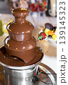 Chocolate Fountain with Fresh Fruit and Strawberry Dessert Close-Up 139145323