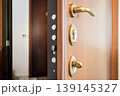 Open Wooden Door with Security Lock and Handle Close-Up 139145327