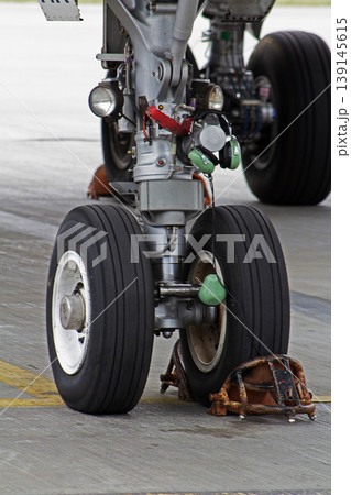 Aircraft landing gear and iron support shoes. Wheels tires tires. Parking plane handling. 139145615