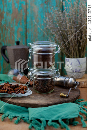 Rustic Coffee Composition with Ground Beans, Whole Roasted Beans, Moka Pot and Star Anise Pods Rustic Coffee Composition with Ground Beans, Whole Roasted Beans, Moka Pot and Star Anise Pods 139145718