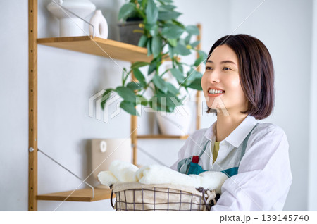 清潔なタオルを抱え笑顔で未来を見つめる女性 139145740