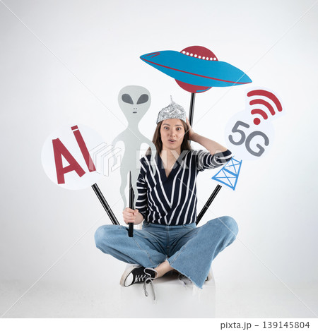 Woman wearing tin foil hat believing conspiracy theories Woman wearing tin foil hat believing conspiracy theories 139145804