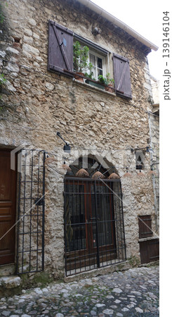 Traditional old stone houses on a street in the medieval town of Saint Paul de Vence, French Riviera, South of France 139146104