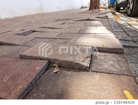 Uneven Sidewalk Caused by Aging Pavement Uneven Sidewalk Caused by Aging Pavement 139146420