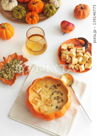 Creamy pumpkin soup with croutons and seeds, served in a pumpkin shaped bowl Creamy pumpkin soup with croutons and seeds, served in a pumpkin shaped bowl 139146773