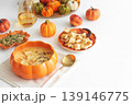 Creamy pumpkin soup with croutons and seeds, served in a pumpkin shaped bowl 139146775