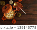 Autumnal lunch with pumpkin soup in a pumpkin shaped bowl, croutons and festive decor 139146778