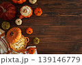 Autumnal lunch with pumpkin soup in a pumpkin-shaped bowl, pumpkin latte, croutons and festive decor 139146779