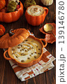 Autumnal lunch with pumpkin soup in a pumpkin-shaped bowl, pumpkin latte, croutons and festive decor 139146780