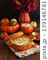 Autumnal lunch with pumpkin soup in a pumpkin-shaped bowl, pumpkin latte, croutons and festive decor 139146781