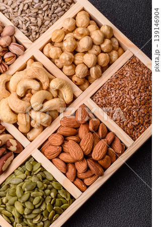 A mix of cashews, pistachios, almonds, macadamia and hazelnuts. Nuts as a food background A mix of cashews, pistachios, almonds, macadamia and hazelnuts. Nuts as a food background 139146904