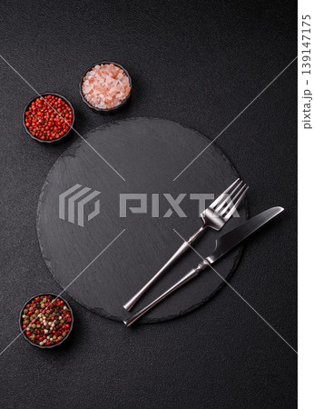 An empty slate cutting board with cutlery on a kitchen counter. Slate cutting board An empty slate cutting board with cutlery on a kitchen counter. Slate cutting board 139147175