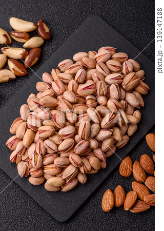 Salted pistachio nuts in shells as a healthy, high calorie food ingredient. Pistachio nuts 139147188