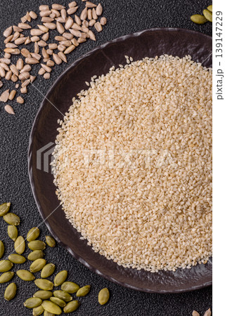 White sesame seeds in a bowl, an ingredient for oil and healthy eating. White sesame White sesame seeds in a bowl, an ingredient for oil and healthy eating. White sesame 139147229