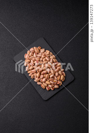 Salted pistachio nuts in shells as a healthy, high calorie food ingredient. Pistachio nuts 139147273
