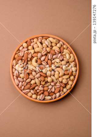 A mix of cashews, pistachios, almonds, macadamia and hazelnuts. Nuts as a food background A mix of cashews, pistachios, almonds, macadamia and hazelnuts. Nuts as a food background 139147276