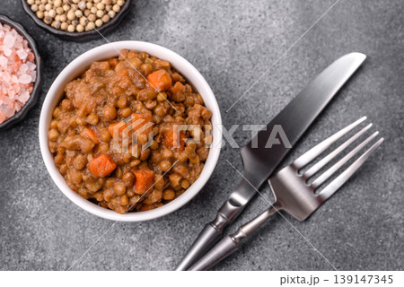 Lentil, carrot, and tomato stew with sausages, a European dish. Lentils with sausages Lentil, carrot, and tomato stew with sausages, a European dish. Lentils with sausages 139147345