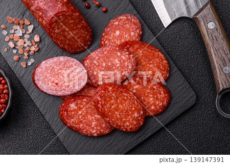 Sliced smoked pepperoni or salami as a pizza topping. Pepperoni sausage Sliced smoked pepperoni or salami as a pizza topping. Pepperoni sausage 139147391