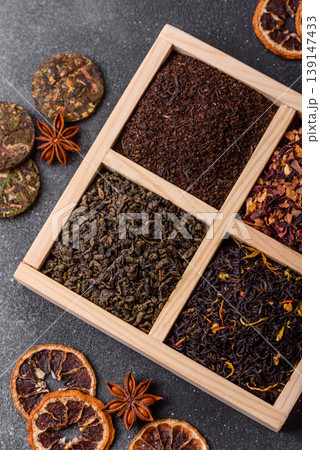 A box of various dry teas, black, green, herbal, and fruit. A set of different tea varieties 139147433