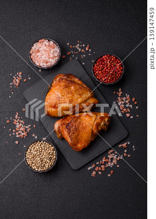 Grilled or barbecued chicken legs, spicy meat cooked with salt and spices. Grilled chicken legs Grilled or barbecued chicken legs, spicy meat cooked with salt and spices. Grilled chicken legs 139147459