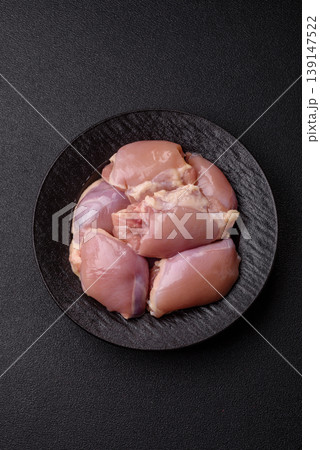 Raw chicken thigh fillet, boneless and skinless, for roasting. Raw thigh fillet Raw chicken thigh fillet, boneless and skinless, for roasting. Raw thigh fillet 139147522