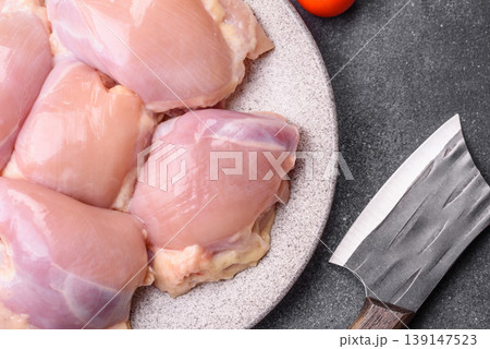Raw chicken thigh fillet, boneless and skinless, for roasting. Raw thigh fillet Raw chicken thigh fillet, boneless and skinless, for roasting. Raw thigh fillet 139147523