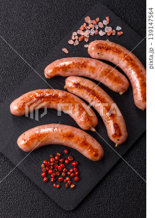 Grilled pork or chicken sausages, smoked fried food with salt and spices. Grilled sausages Grilled pork or chicken sausages, smoked fried food with salt and spices. Grilled sausages 139147564