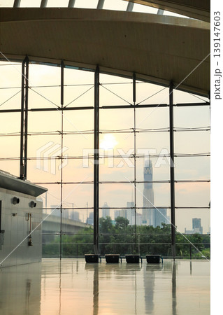 Modern glass wall in the office building, modern glass building, skyscrapers with sky background. Modern glass wall in the office building, modern glass building, skyscrapers with sky background. 139147603