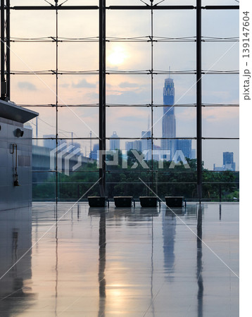 Modern glass wall in the office building, modern glass building, skyscrapers with sky background. 139147604