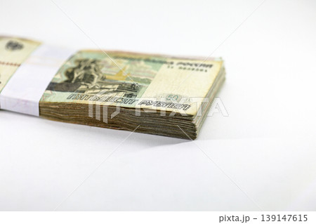 Many packs of Russian Ruble bills, stacks of banknotes, pile of cash, paper money. The concept of financial success, Investment and wealth. isolate on white background. Many packs of Russian Ruble bills, stacks of banknotes, pile of cash, paper money. The concept of financial success, Investment and wealth. isolate on white background. 139147615