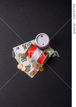 A barrel of oil against a backdrop of euro as a concept for the oil crisis. A barrel of oil A barrel of oil against a backdrop of euro as a concept for the oil crisis. A barrel of oil 139147702