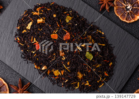 Dry black tea with herbal leaves and aromatic additives. Dry fruity black tea 139147729