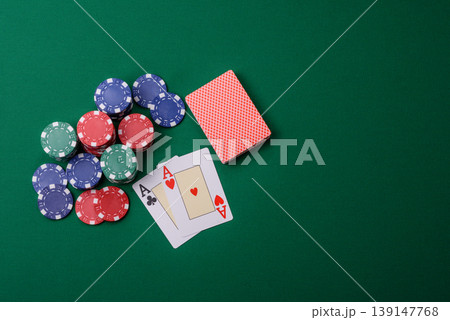 Playing cards and chips on a green cloth, a gambling game of blackjack or baccarat. Cards and chips Playing cards and chips on a green cloth, a gambling game of blackjack or baccarat. Cards and chips 139147768