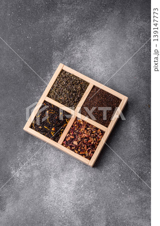 A box of various dry teas, black, green, herbal, and fruit. A set of different tea varieties 139147773