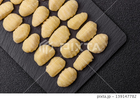 Raw homemade potato gnocchi, made with salt and spices, ready for lunch. Raw gnocchi Raw homemade potato gnocchi, made with salt and spices, ready for lunch. Raw gnocchi 139147782