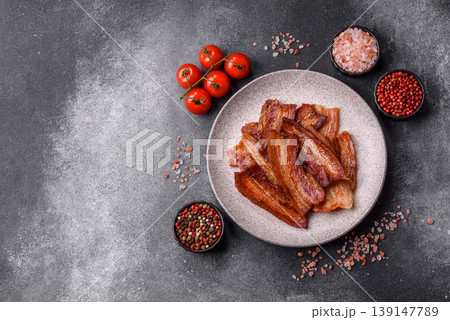 Fried fresh bacon slices with layers of meat or prosciutto prepared for breakfast. Fried bacon 139147789