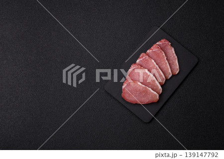 Smoked or dry cured meat slices, pork or ham with salt and spices. Smoked meat slices 139147792