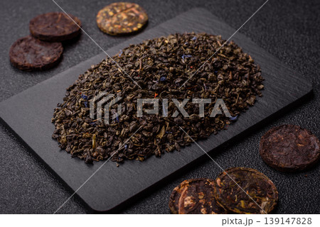 Granules of dried organic Chinese green tea with herbal additives. Dry green tea 139147828
