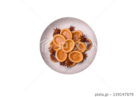 Round mini tartlets with citrus or peach jam and crumbly pastry. Mini citrus tarts Round mini tartlets with citrus or peach jam and crumbly pastry. Mini citrus tarts 139147879